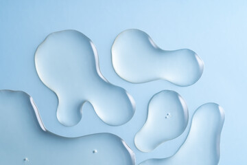 Close up Clear liquid cosmetic product. Gel texture with bubbles, skin care product on blue...