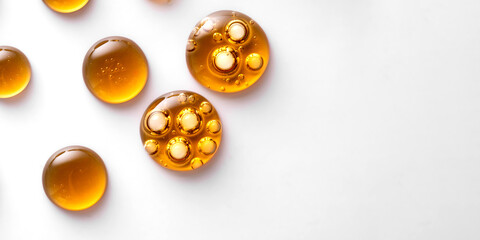 Fototapeta premium Drops of yellow oil swatch texture macro with bubbles, cosmetics for face and body, science, laboratory isolated on white background