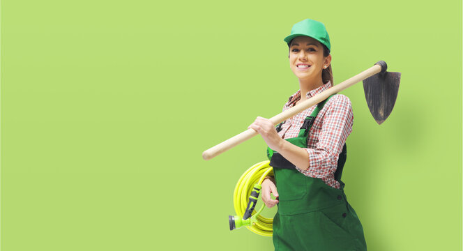 Female gardener posing with a hoe