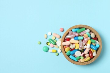 Various pills in a bowl on color background