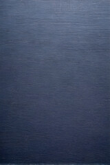 The textured background is dark blue with fine irregularities and relief