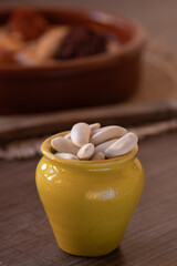 Fabada beans in a yellow ceramic pot, main ingredient of the Asturian fabada
