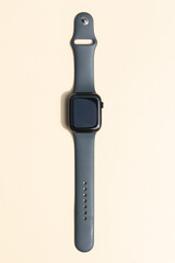 Black Smartwatch Resting on Minimal Beige Background