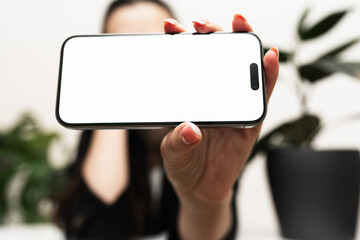 Obraz premium mock up phone in woman hand showing white screen