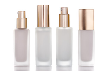 Group of glass cosmetic bottles isolated on white background with, lotion pump and spray pump.