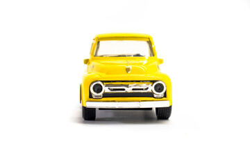 Yellow pickup truck toy isolated on white background. Children's toys. Transport concept © Denis