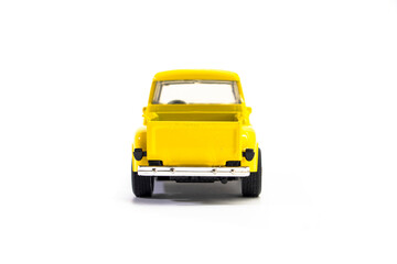 Yellow pickup truck toy isolated on white background. Children's toys. Transport concept © Denis