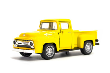Yellow pickup truck toy isolated on white background. Children's toys. Transport concept © Denis