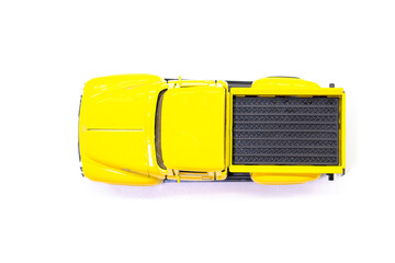 Yellow pickup truck toy isolated on white background. Children's toys. Transport concept © Denis