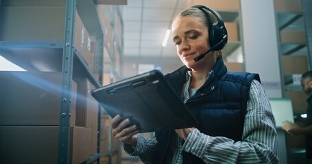 Female Customer Support Specialist in Logistics in Headset Talks on Call with Client, Uses Tablet...