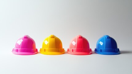 A minimalistic close-up of four vibrant hard hats placed on a clean white background, showcasing organization and architectural precision.