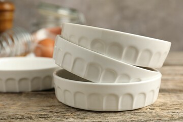 Ceramic casseroles on wooden table, closeup. Cooking utensil