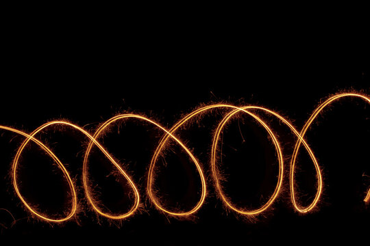 sparklers freezelight figure on black background