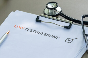 Minimalist medical workspace with a clipboard marked "Low Testosterone" and a stethoscope nearby.