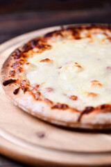 Pizza margherita on wooden background. Soft focus. Close up