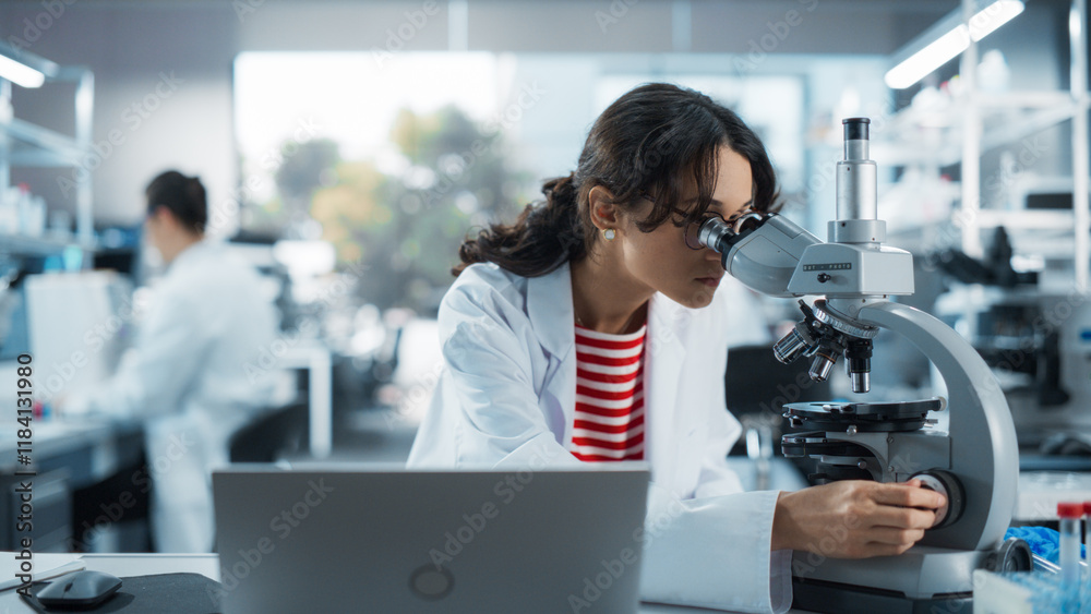 Poster medical research scientist looking at biological samples under a microscope in an applied science la