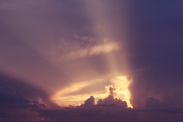 Fototapeta premium Dramatic sky with the sun shining behind clouds