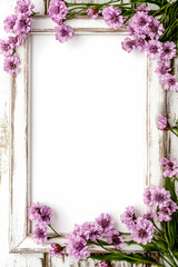 Purple flowers frame on white wood background,  perfect for spring greetings or invitations