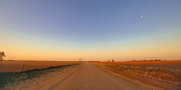 Dirt road on the plains in rural Victoria at sunset