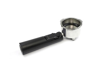 portafilter for brewing espresso coffee under pressure of a coffee machine with small holes in the holder with a brass iron bayonet and a plastic black handle top view isolated on white.