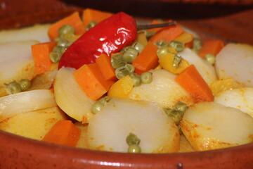 Close up of Moroccan Tajine with potatoes, carrots, peas