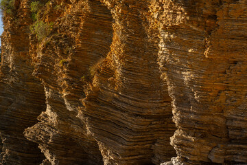 layered rocks of the sea cliff in Budva.