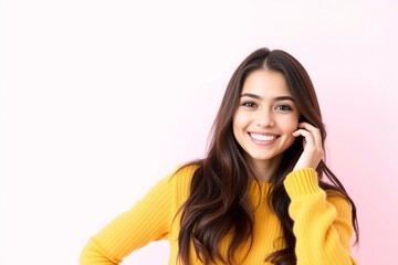 Fototapeta premium Smiling young brunette woman girl in yellow sweater posing isolated on pastel pink wall background, studio portrait. People sincere emotions lifestyle concept. Mock up copy space. Looking camera