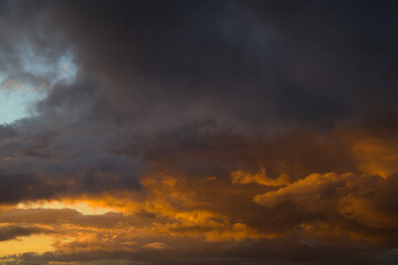 Sky with orange clouds in autumn sunset horizontal
