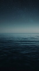 Obraz premium A breathtaking display unfolds as the night sky sparkles with countless stars, perfectly reflected on the calm sea. The stillness of the water enhances the tranquil beauty of the celestial view