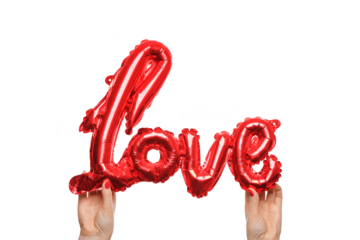 Hands grasp a shiny red balloon shaped like the word love, against a white background