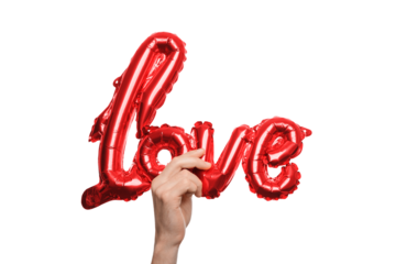 Hand holding shiny red balloon shaped like the word love, symbolizing romance and affection