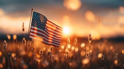 American flag waves at sunset, bathed in golden light, a serene and patriotic scene.