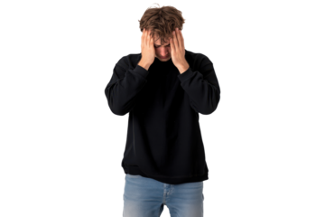 Frustrated man covering his face with hands wearing a black sweater and jeans, isolated on transparent background