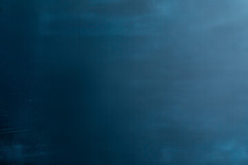 Obraz premium A smooth, dark blue surface with subtle texture, evoking a sense of calm and depth.