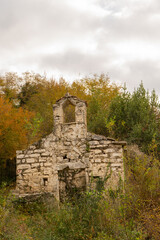 ruins of an ancient church in an autumn forest.