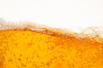 Close up bright orange Oil or beer splash texture and nature waves, Beautiful waves curve and little bubbles smooth for graphic design and background, Oil Bubbles, Soft beer bubbles, Selective focus