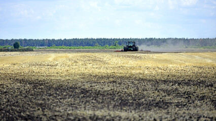 Ukraine. tractor in a field, tractor with a plow on an agricultural field. working in the field, soil preparation, agriculture. agricultural technology, farmland.