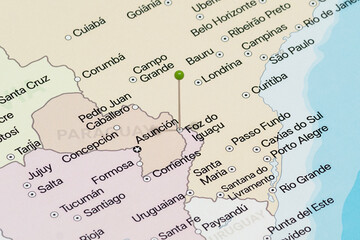 Macro photo of a green pin needle into Foz do Iguacu city of Brazil political map