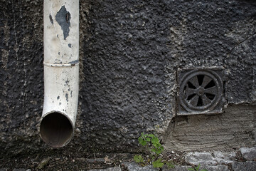 Old drain pipe with peeling paint.