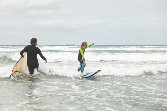 Young boy learning to surf in Portland Victoria