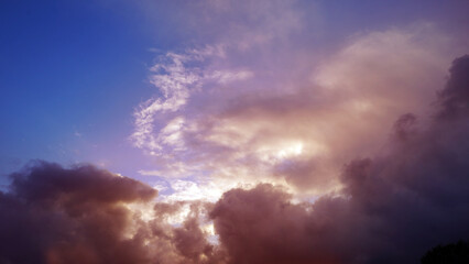 Obraz premium Sun Within Dark Clouds at a Purple and Red Sunset