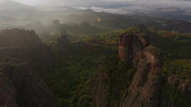 Aerial view of belogradchik fortress at sunrise surrounded by majestic rock formations and serene mist, belogradchik, bulgaria.