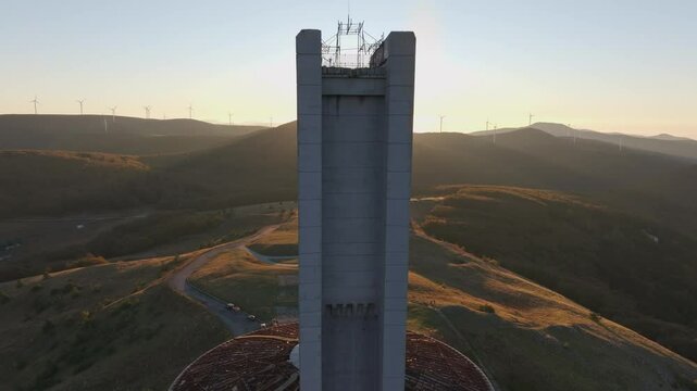 Aerial view of the abandoned buzludzha monument at sunrise surrounded by majestic mountains and serene valleys, Kran, Bulgaria.