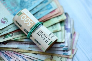 Big amount of different ukrainian hryvnia currency money bills on wooden background
