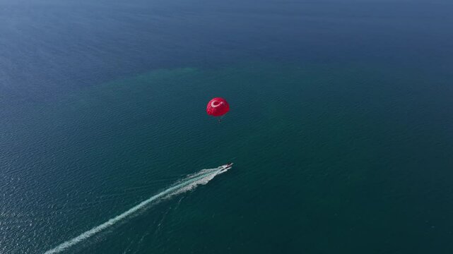 Aerial view of parasailing over the beautiful Mediterranean Sea with turquoise waters and a scenic coastline, Fethiye, Turkey.