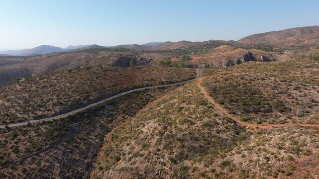 Aerial view of a winding road through rugged hills and barren terrain, Milas, Turkey.