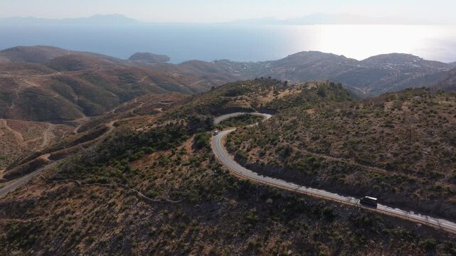 Aerial view of winding road through majestic mountains and serene valley, Milas, Turkey.