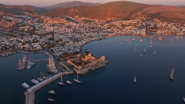 Aerial view of bodrum castle at sunset over the aegean sea with boats in the harbor, bodrum, turkey.