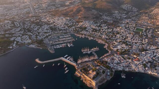 Aerial view of bodrum castle at sunset overlooking the aegean sea with boats and cityscape, bodrum, turkey.
