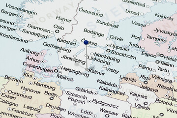 Macro photo of a blue pin needle into Kalmar city of Sweden political map  © Alejandro Bernal